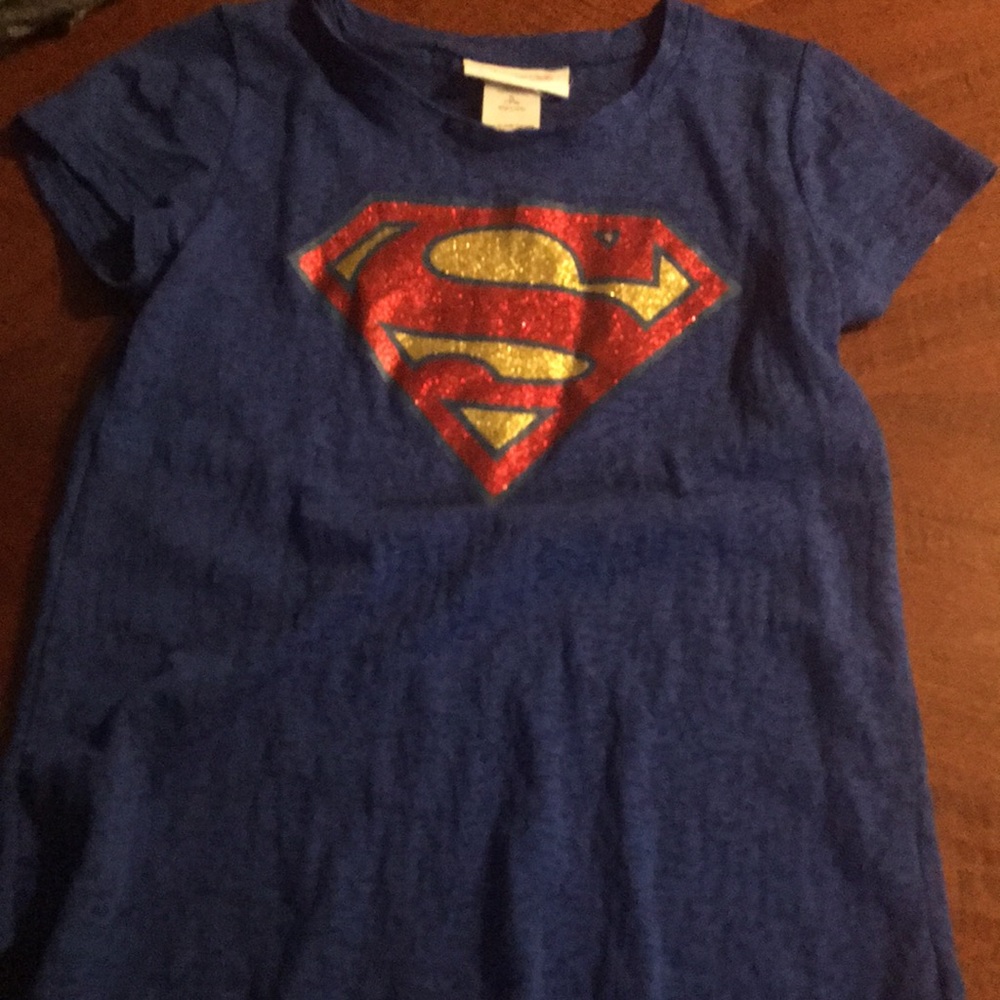 A blue shirt with Superman logo